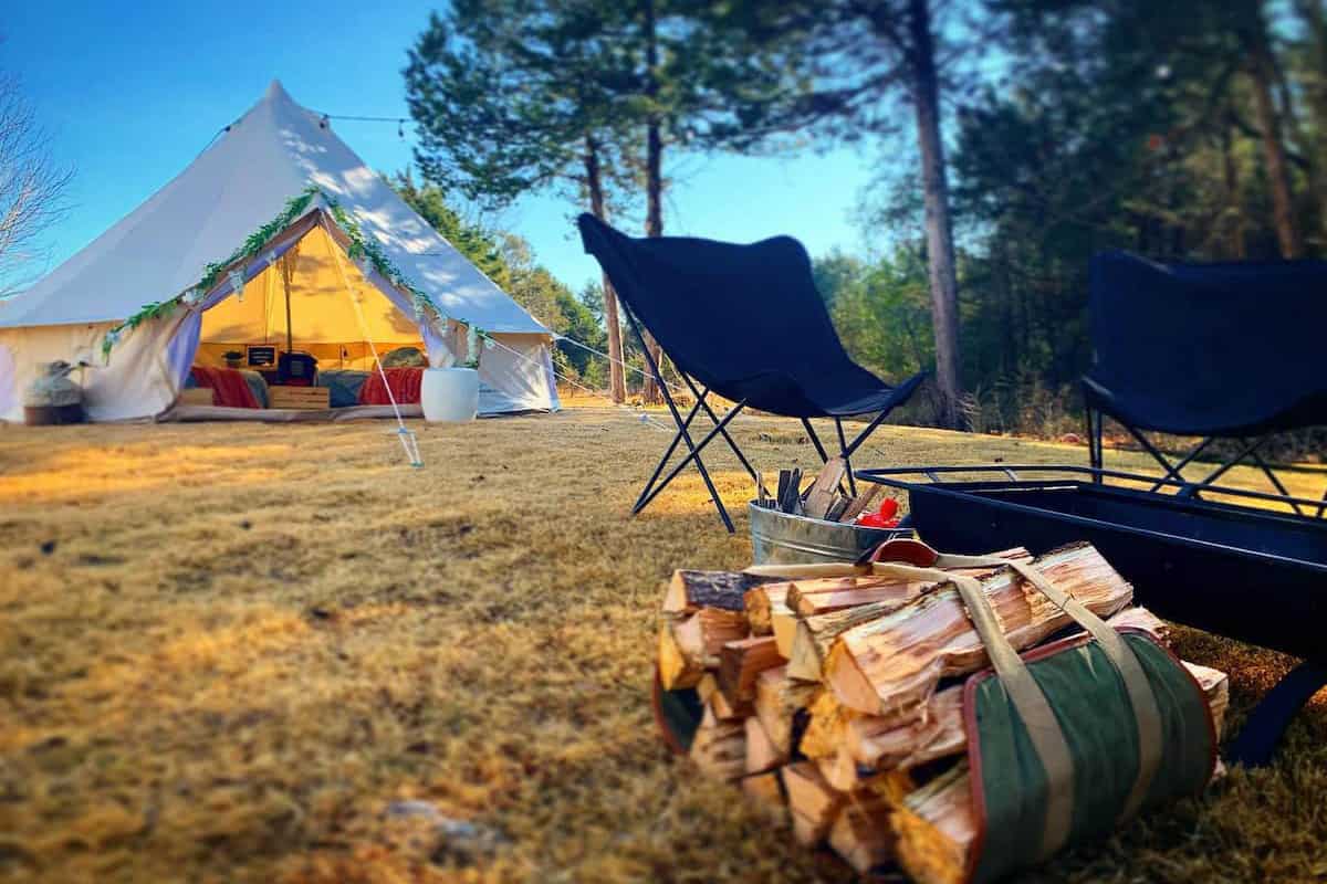 Best Glamping Arkansas Spots view of glamping bell tent with firepit and wood