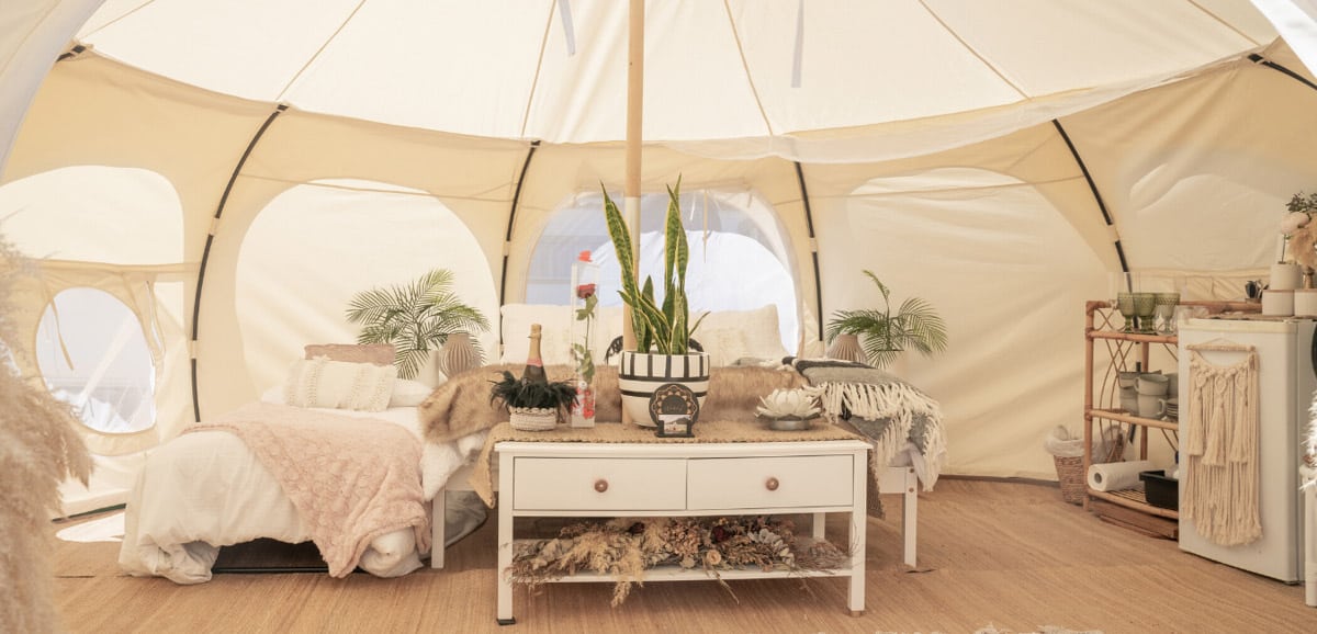glamping tent inside with bed and furniture
