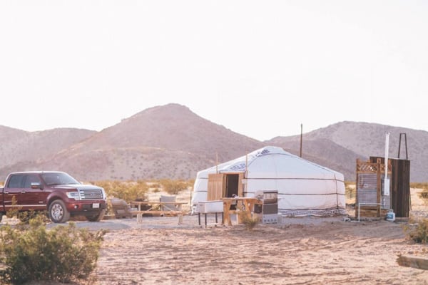 28 Palms Ranch Stargazing Yurt view of outside with shower and tables and truck