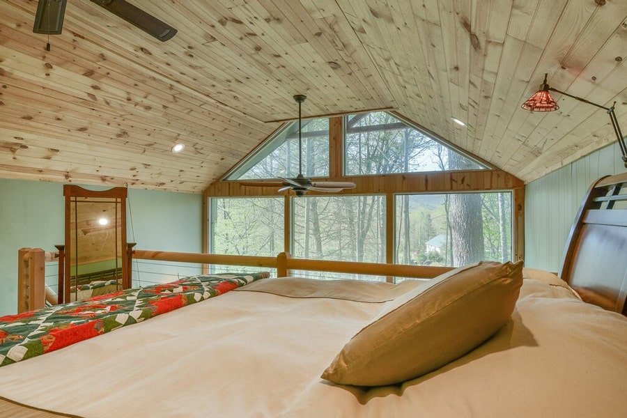 Upper Stone Mountain Glamping Treehouse view from loft with bed and windows