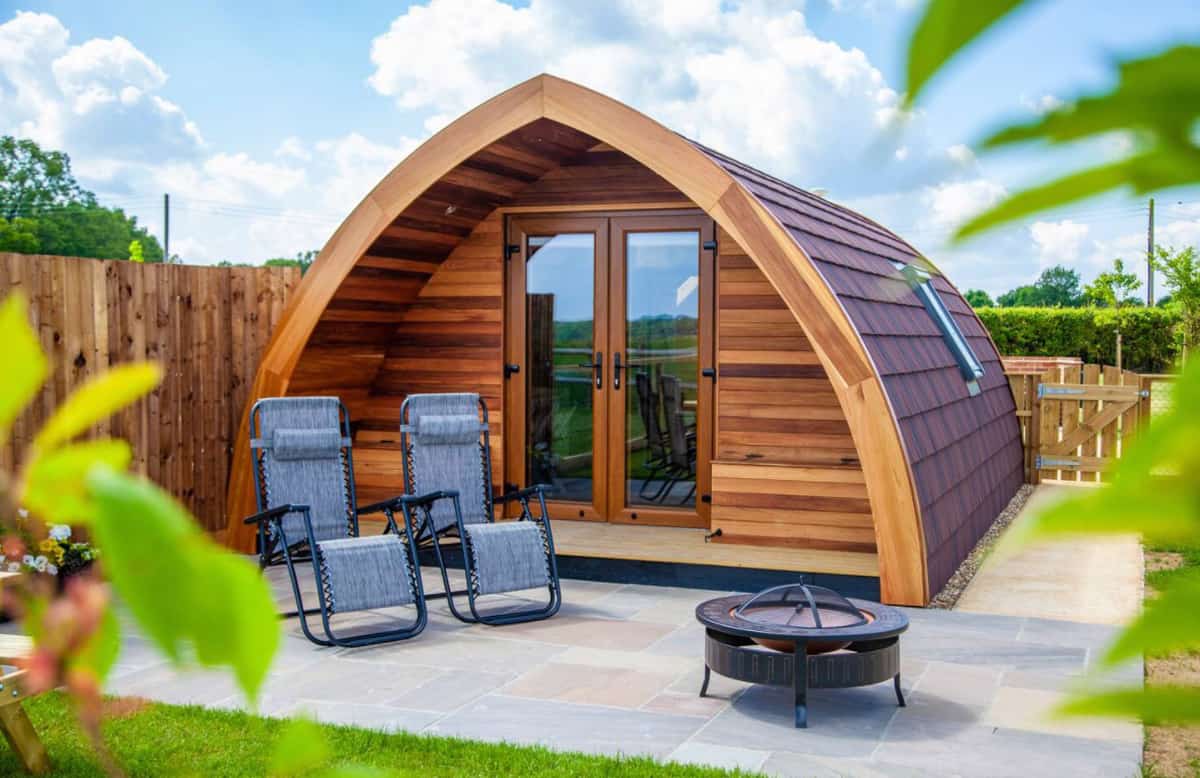 a glamping pod Essex with view of the glamping pod and chairs and fire pit