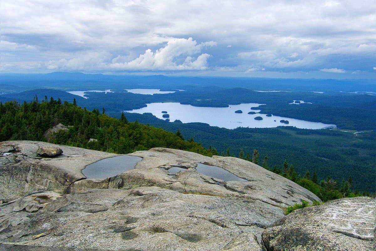Awesome Glamping in the Adirondacks NY view from the ledge of a mountain with lakes below