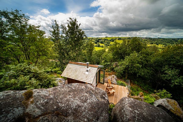 glamping cabin peak district nestled in boulders and a view of the valley below