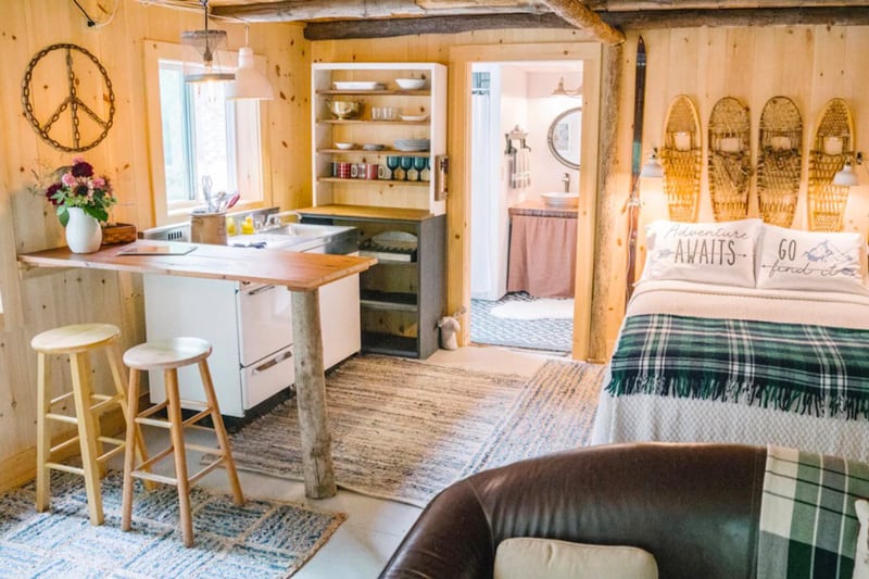 Vermont Glamping Barn on 40 Acres view of inside with bed, kitchen and bathroom