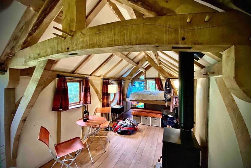 glamping wales bird hide inside view with bed and stove