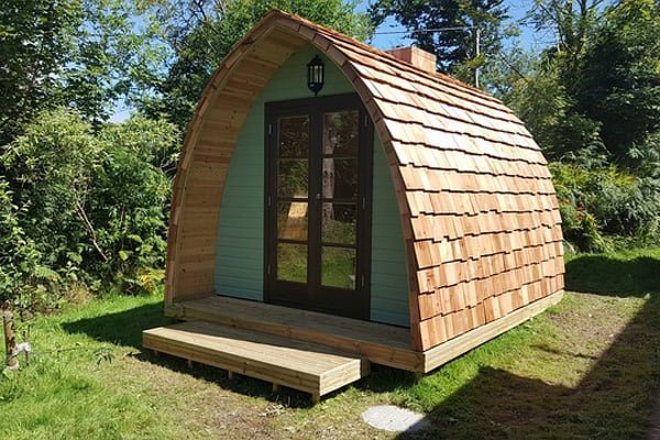 wooden pod glamping view of the pod with step deck and french doors