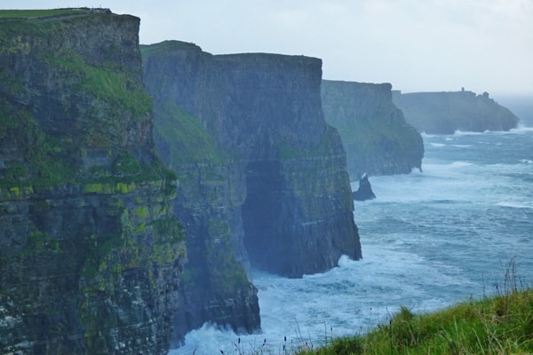 cliffs of moher glamping ireland spot, views of green massive cliffs with the sea below