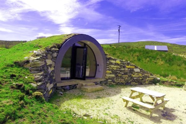 Cropod Glamping Donegal Hobbit house view of the front of the glamping pod with green fields behind
