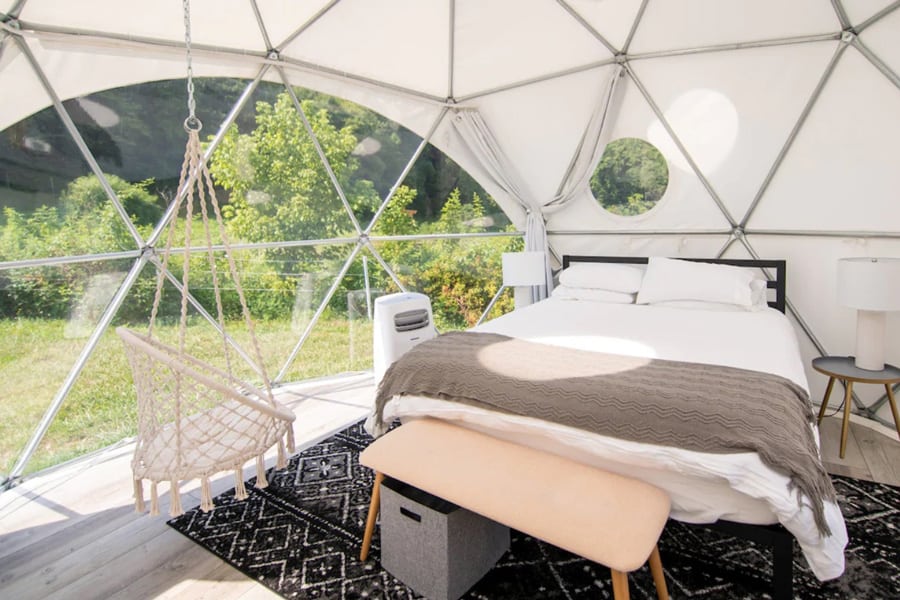 The Glamping Smoky Mountains Dome view of inside with bed, chair hammock and windows