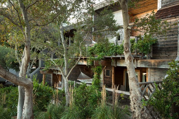 Ventana Big Sur Glamping Resort wooden two story building view through the trees with balconies and hammock