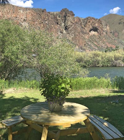 view from table with river at the gypsy wagon glamping in idaho location