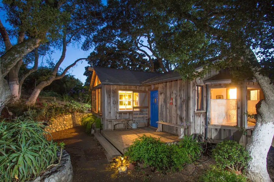 Big Sur Glamping Goat Farm tiny home view of home at night with trees around