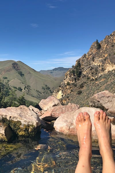 view from Goldbug Hot Springs Trail with feet and mountains while glamping in idaho