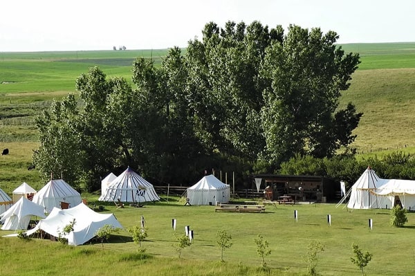 Good Knights Encampment Unique Glamping view of the medieval encampment in a grassy field with multiple tents