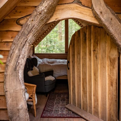 view of wooden hobbit doorway with bed inside