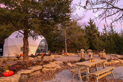 Kimberly Creek Retreat glamping Nebraska dome view of white dome in fall with picnic table