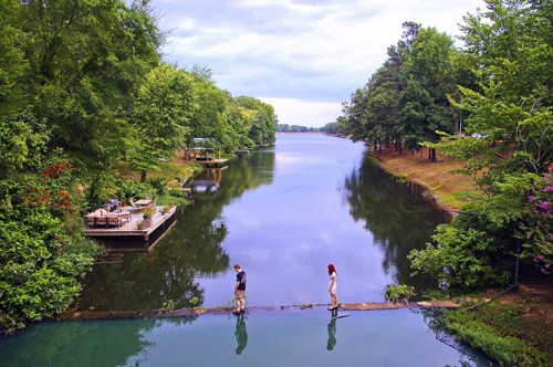 view of 2 people walking across foot bridge on lake number two in Arkansas
