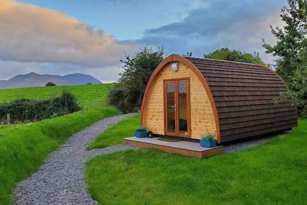 Luxury Glamping Pods in Killarney at Farmyard Lane with view of the pod and the Irish countryside