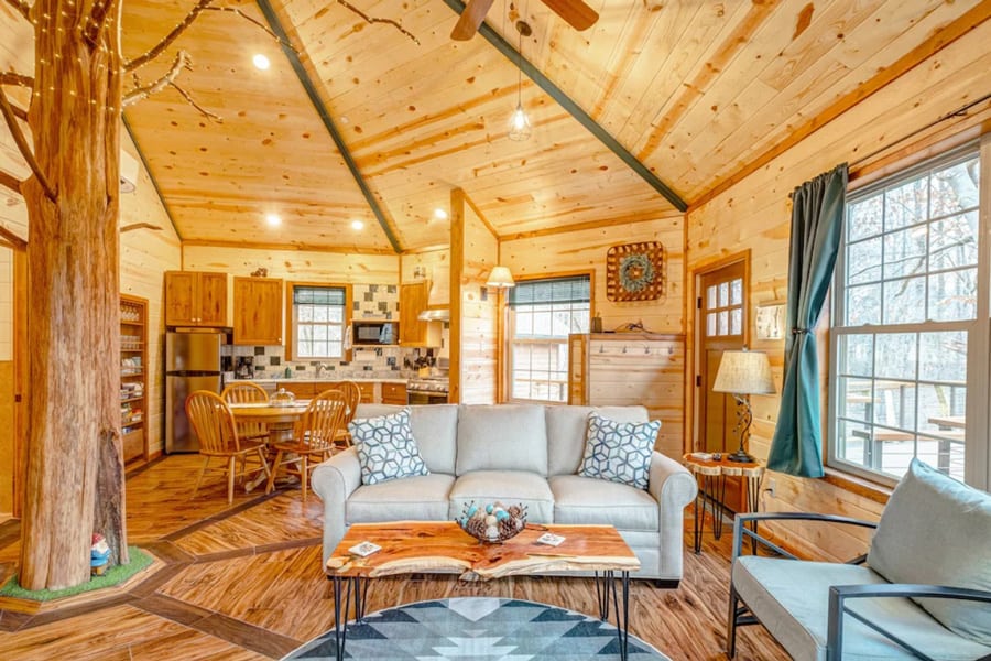 Luxury Treehouse -  Glamping Nashville Area Getaway view of inside. All wood with tree growing through room, windows, couch and kitchen