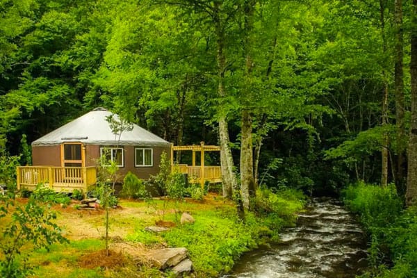 Luxury Yurt Camping NC on a Creek view of the yurt with deck and river running next to it
