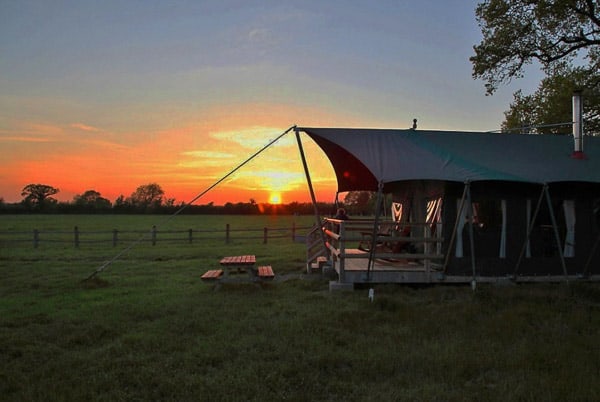 glamping tent with a sunset in the background