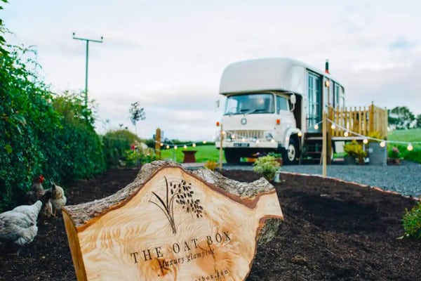 The Oat Box Converted Horsebox Glamping in Limavady view of sign with horsebox in background
