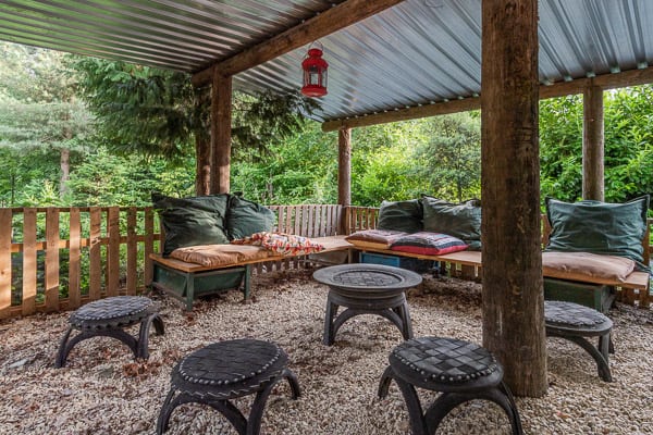 seating area with pillows and tables for glamping cotswolds
