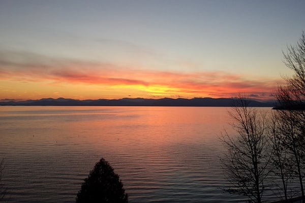 sunset on lake Champlain while glamping Vermont