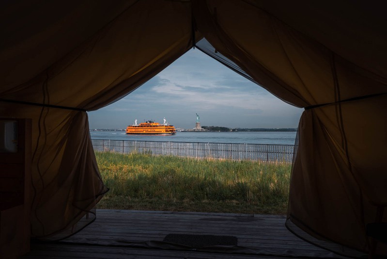 View of Statue of Liberty and Staten Island Ferry from Governors Island glamping Collective Retreats.