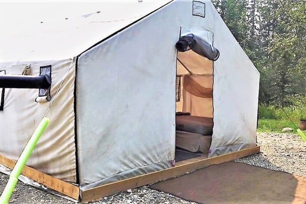 Winter Prospectors Alberta Glamping Tent close up view of the front door with bed inside
