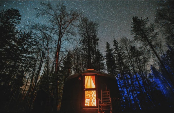 Yurt at night with star and trees while Glamping Idaho